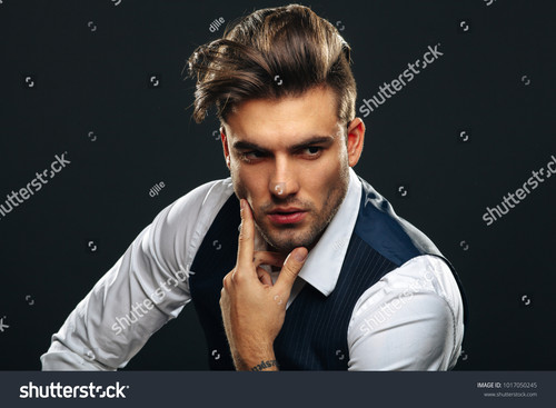 stock photo portrait od handsome man in studio on dark background 1017050245.jpg