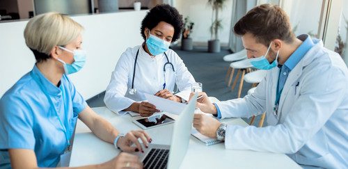 african american doctor analyzing medical reports with her colleagues clinic.jpg