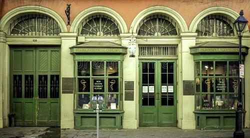 pharmacy museum storefront historical store front new orleans green doors cream colored window trim .jpg