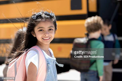 cute schoolgirl excited for the first day of school.jpg
