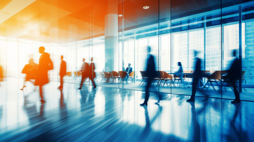business people running around in a spacious hall and having meeting at table Abstract blurred offic.jpg