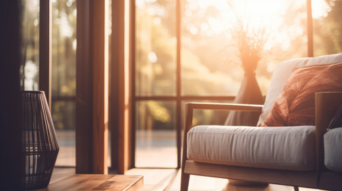 Blur image of living room with furniture at home with sunlight for background usage stock wallpaper .jpg