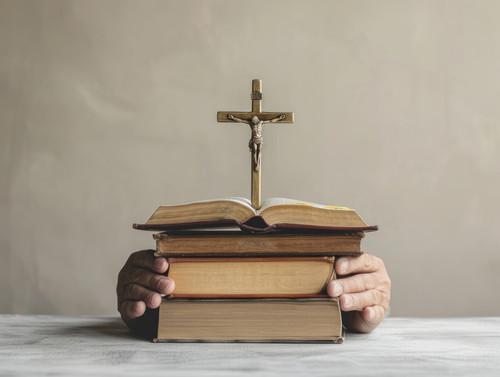 pastel colors white background isolated Bible with christian crucifix in hands of man studying catho.jpg