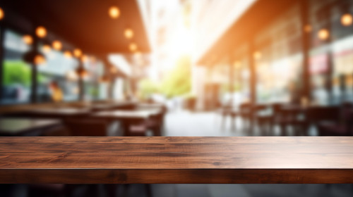 Blurred coffee shop and restaurant interior background with empty wooden table Use for products disp.jpg