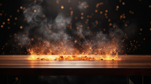 wooden table with Fire burning at the edge of the table fire particles sparks and smoke in the air w.jpg