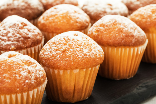 Close-up of vanilla muffins in powdered sugar. Selective focus..jpg