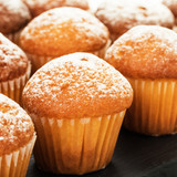 Close-up of vanilla muffins in powdered sugar. Selective focus.