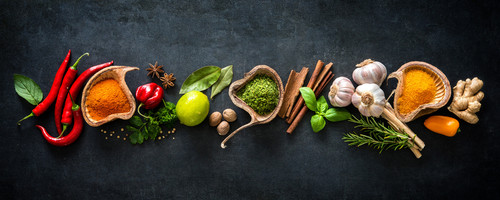 Various herbs and spices on dark background.jpg