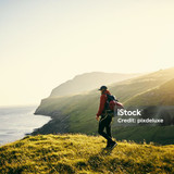Shot of a young man hiking through the mountains