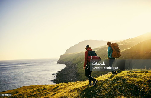 Shot of a young couple hiking through the mountains.jpg