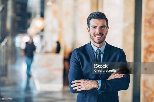 Businessman with arms crossed looking at camera.jpg
