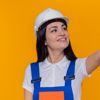 mujer joven constructor uniforme construccion casco seguridad mirando lado sonriendo confiado mostra.jpg