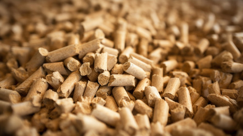 A pile of organic biofuel wooden pellets made from compacted sawdust and byproduct of woodworking op.jpg