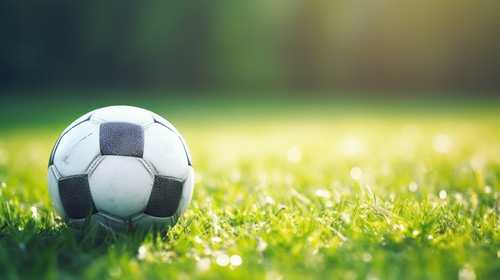 A football ball amongst sports newspapers on a green field Symbol of the power of sports journalism .jpg