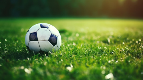 A football ball amongst sports newspapers on a green field Symbol of the power of sports journalism .jpg
