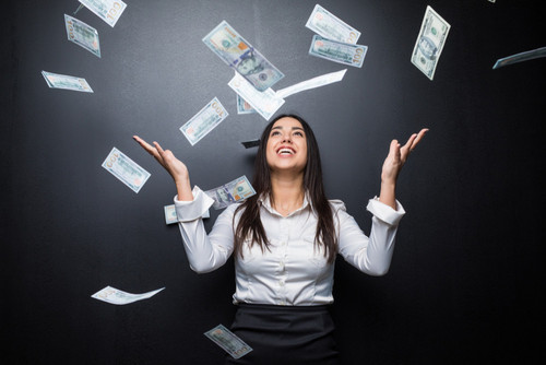 happy business woman money rain made dollars isolated black wall.jpg