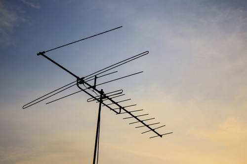 An old antenna silhouetted in sunset sky background.jpg