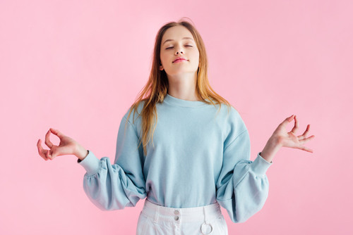 stock photo pretty teenage girl closed eyes meditating isolated pink.jpg