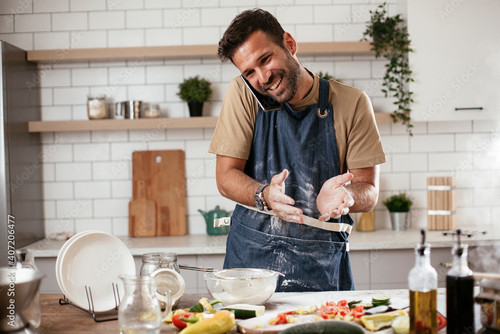 random man cooking talking phone.jpg