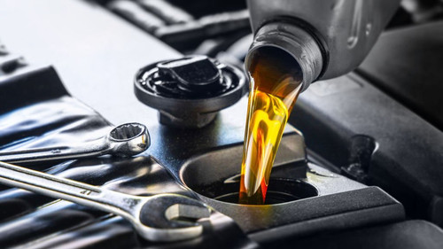 Pouring motor oil for motor vehicles from a gray bottle into the engine, ,  oil change,  auto repair.jpg