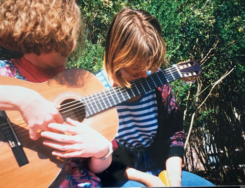 Fels shows her harmonics playing technique.jpg