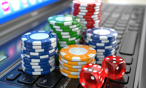 Virtual casino. Online gambling. Laptop with dice and chips..jpg