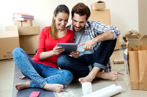 Portrait of Young couple with digital tablet in their new home.jpg