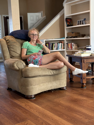 Pasiley Shorts Green Top Legs Crossed Smiling.jpg