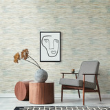 Stylish minimalistic interior of living room with design rattan armchair, pillow, plaid, beige macra