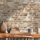 Interior design of neutral bohemian living room interior with stylish desk, armchair, dried flowers 