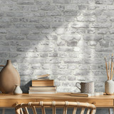 Interior design of neutral bohemian living room interior with stylish desk, armchair, dried flowers 