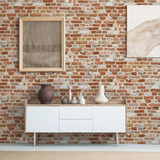 Front view of burlap artworks on a light gray wall above a wooden cupboard with decorations in real 