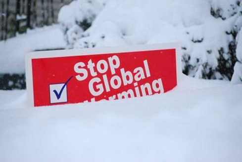 stop global warming sign buried in snow.jpg