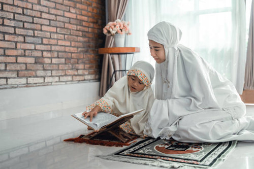 mother and kid reading quran together at home.jpg
