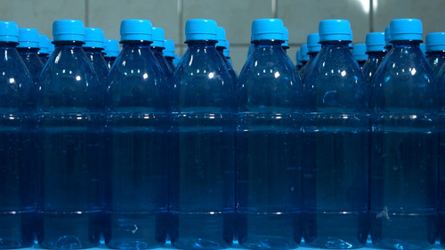 Rows of water bottles. Front view of plastic bottles. Raise profit by improving quality. Cleanliness.jpg