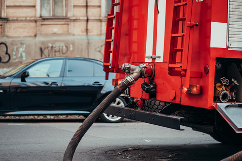 Hoses to quench the fire connecting with water pump valves of fire truck and turn on water to fire f.jpg