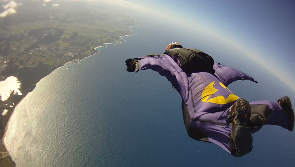 Squirrelsuit flying over the ocean