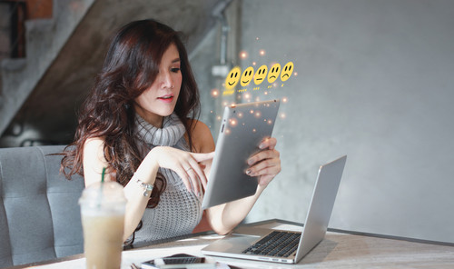 Customer satisfaction survey experience concept, happy asian woman sitting and pressing smiling face.jpg