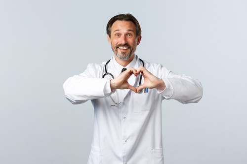 Covid-19, coronavirus outbreak, healthcare workers and pandemic concept. Happy caring male doctor in.jpg