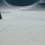 Detail of the view of a ramp used as obstacle to make tricks in an empty urban skate park. Useful as