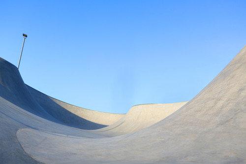 outdoor skatepark with blue sky and grey concrete in harwich, essex, uk.jpg