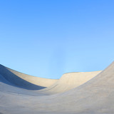 outdoor skatepark with blue sky and grey concrete in harwich, essex, uk