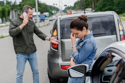 stock photo upset man woman cars car accident.jpg