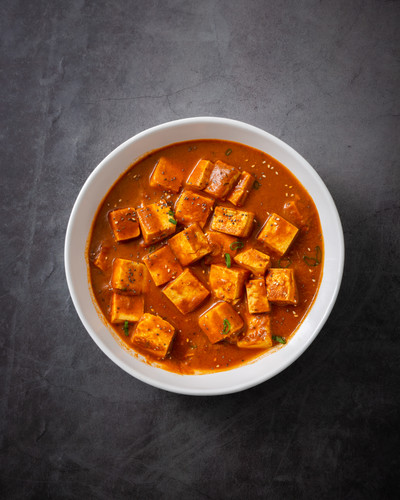 vertical shot traditional indian paneer butter masala cheese cottage curry black surface.jpg