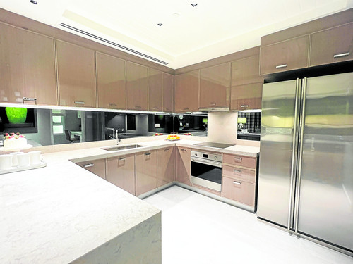 The kitchen is adorned with sleek finishes and ample counter space, making it the perfect place to p