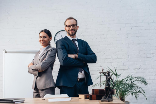 stock photo lawyers suits standing crossed arms looking camera office.jpg
