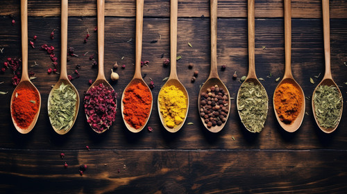 Top view on mixed dry colorful spices in wooden spoons on rustic table Food and cooking ingredients .jpg