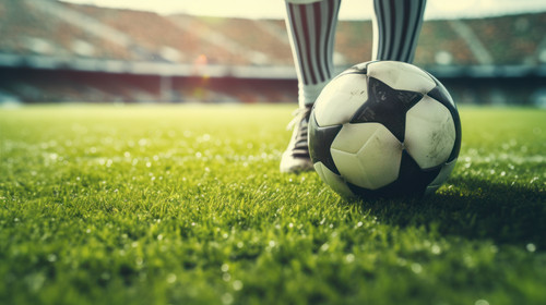 Foot of soccer player or football player walk on green grass ready to play match with soccer stadium.jpg