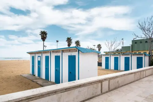 changing rooms beach blue changing rooms wide beach golden sand 145745067.webp