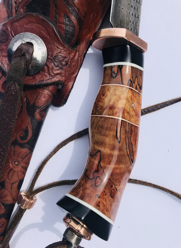 “Pig sticker” forged from an old rasp. Guard, butt cap finial and lanyard bead are coin mokume gane, with domed copper pins. Handle is spalted tamarind, maple burl, and black paper micarta, with G10 and copper spacers. Tooled leather Mexican loop sheath with Sheridan style pattern and domed coin concho.